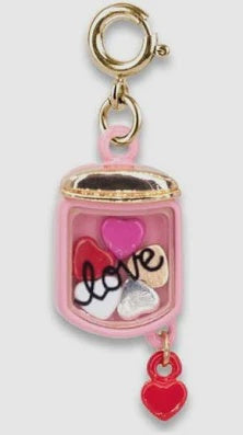 pink charm with love on it and hearts inside