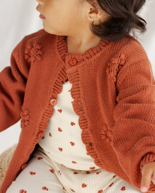rusty red cardigan with hearts.